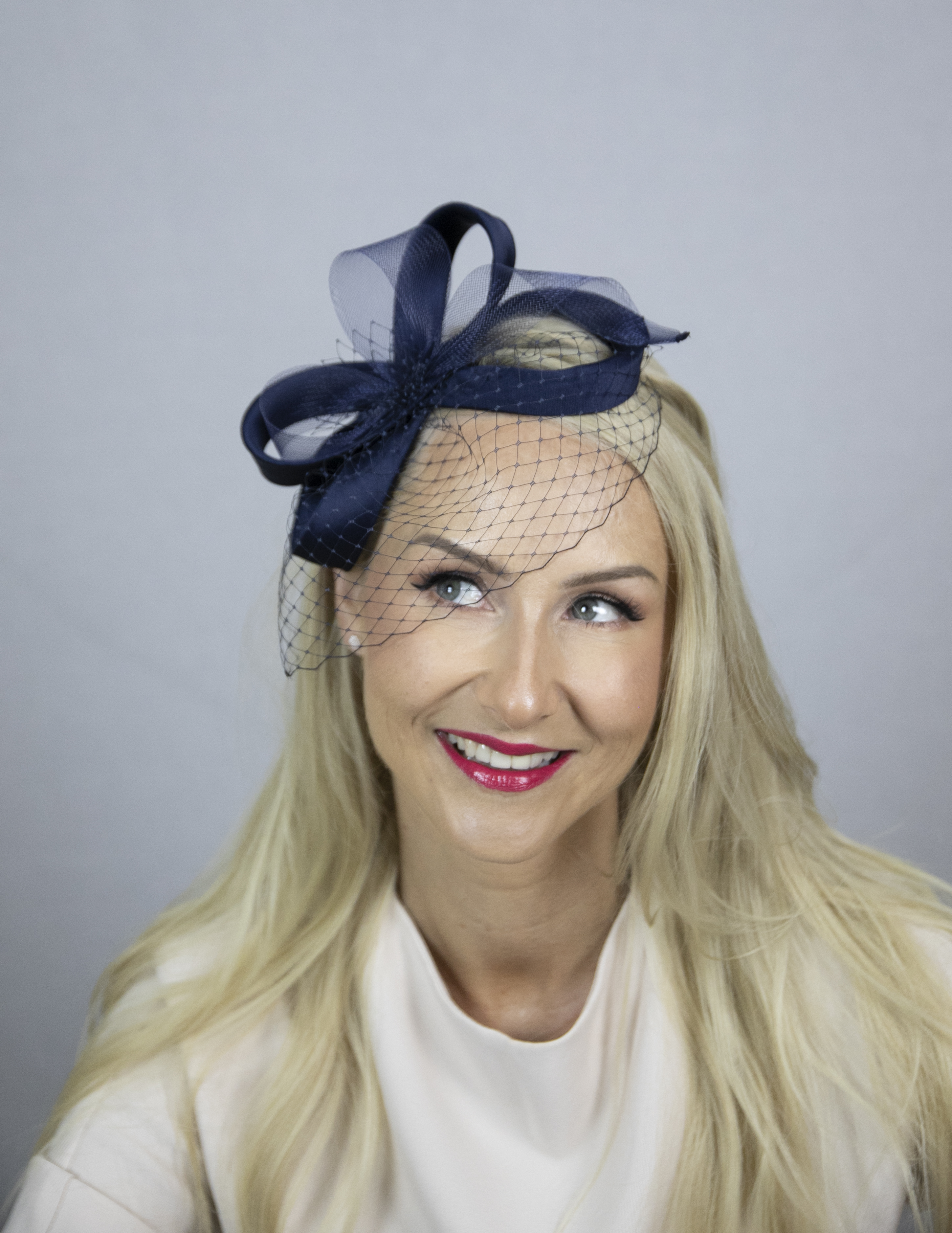 Blue fascinator with veil.