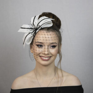 Black and white cute bow fascinator with face veil.