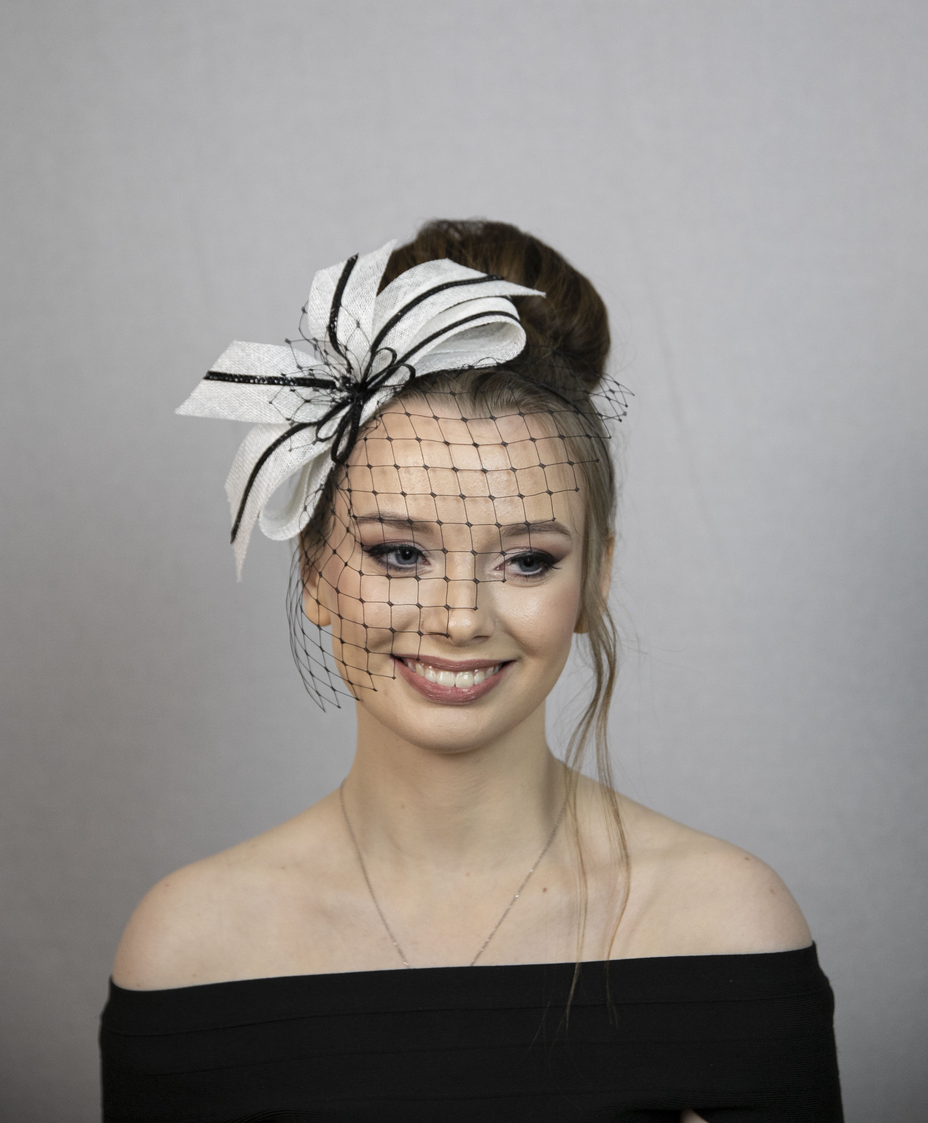 Black and white cute bow fascinator with face veil.