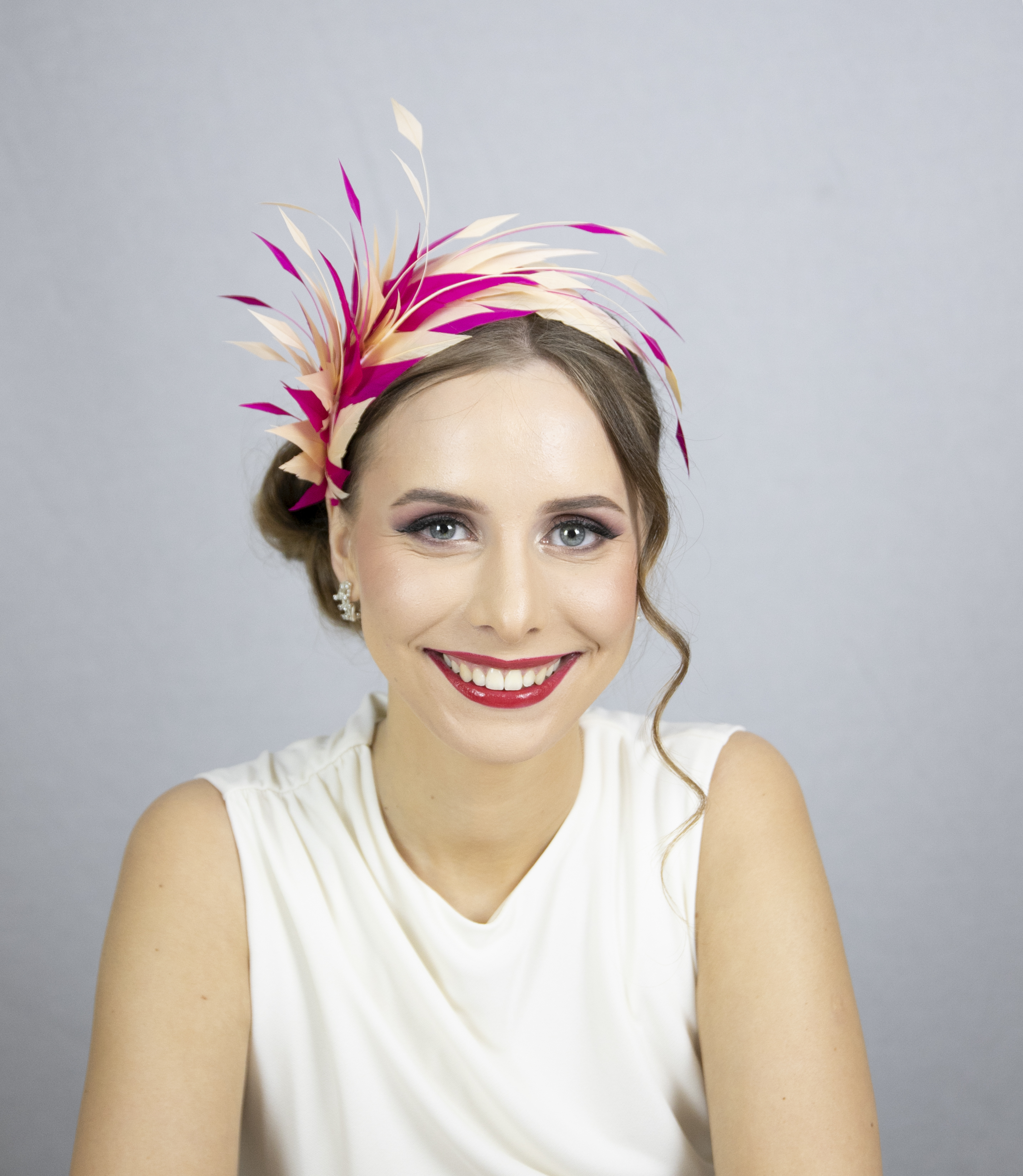 Pink and beige feather fascinator.