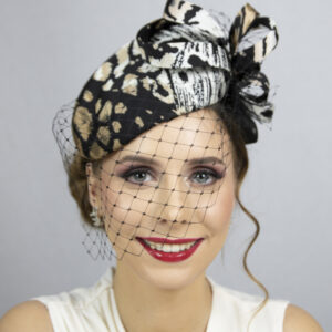 Animal print silk percher hat with face veil.