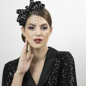 Black and white polka dot fascinator with veil.