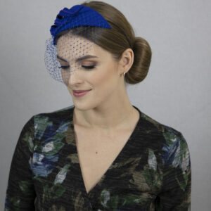 Royal blue fascinator hat with net.